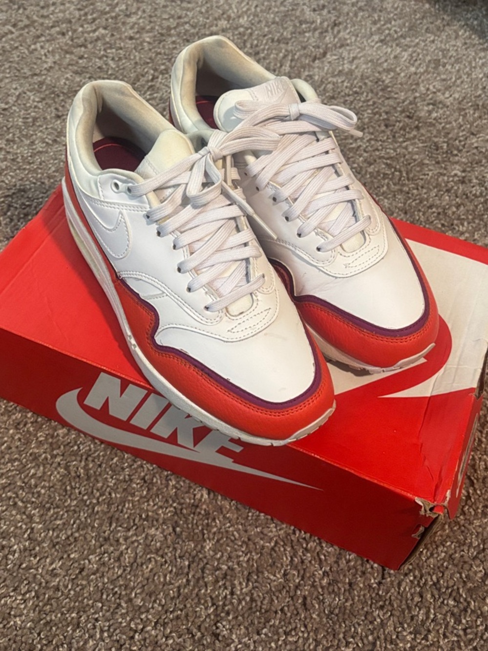 Women’s White and Orange Nike Air Max 1 Sneakers